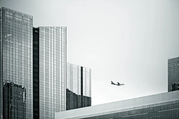 Plane passing between buildings with futuristic lines, in Marginal Pinheiros. Sao Paulo Brazil