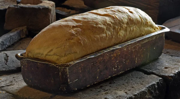 Homemade bread over a wood-fired oven under hot light. Brazil