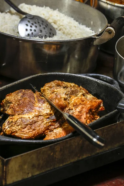 Brazilian cuisine: cooked pork, preserved in lard and fried at the time of serving