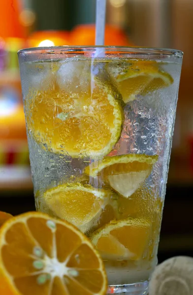 Caipirinha, the traditional Brazilian drink, with pink lemon, with a background in warm tones