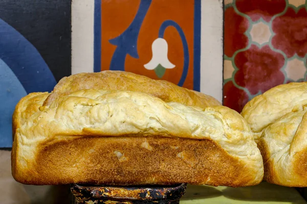 Fresh handmade bread upon bread form, ready to be served