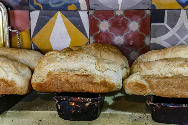 Fresh handmade bread upon bread form, ready to be served