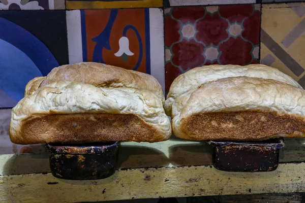 Fresh handmade bread upon bread form, ready to be served