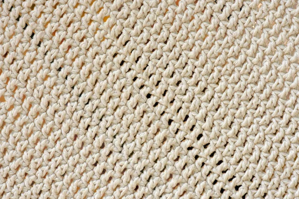 Closeup of crochet rug of thick line of raw cotton