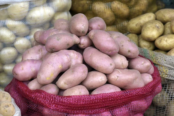 Bulk potato bags in open air market stall