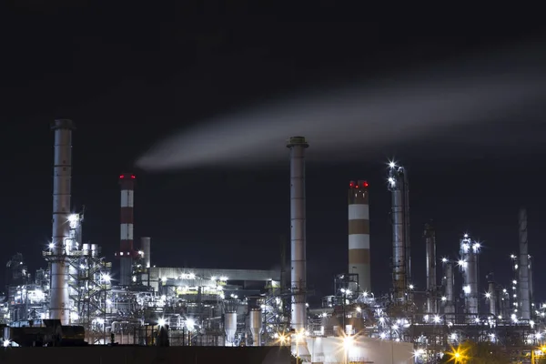 OIL INDUSTRY REFINERY PETROL FACTORY IN NIGHT LIGHT. VIENNA AUSTRIA