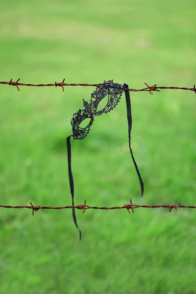 Masquerade Mask Hanging Barbed Wire Blurred Green Background — Stock Photo, Image