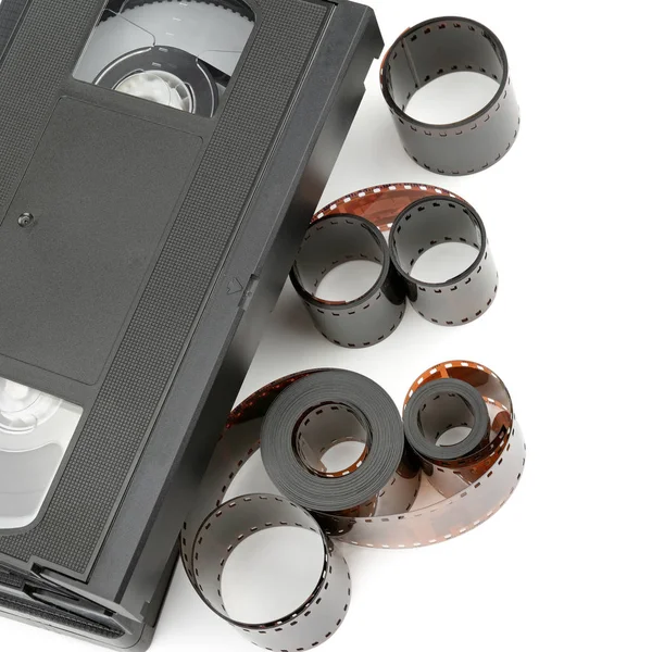 A set of video tapes and photographic film isolated on white background. Flat lay, top view. Retro equipment.