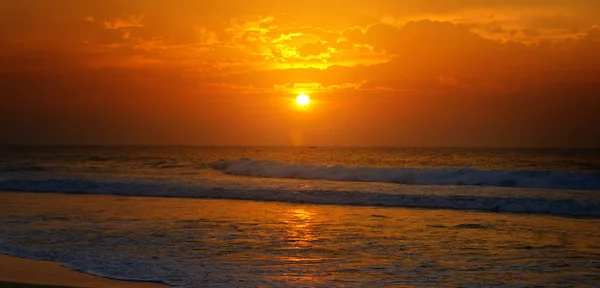 Beach of the ocean and golden sun rise. Bright beautiful background. Wide photo.