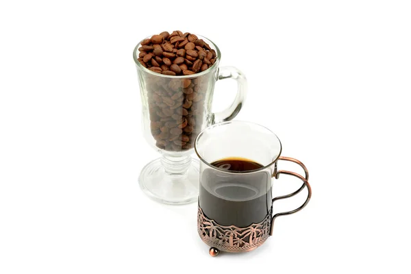 Hot coffee in a delicate glass and coffee beans isolated on white background.