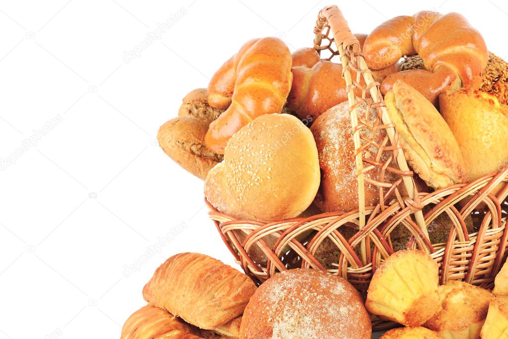 Sweet pastries, bread and flour products in a wicker basket isolated on white background. Free space for text.