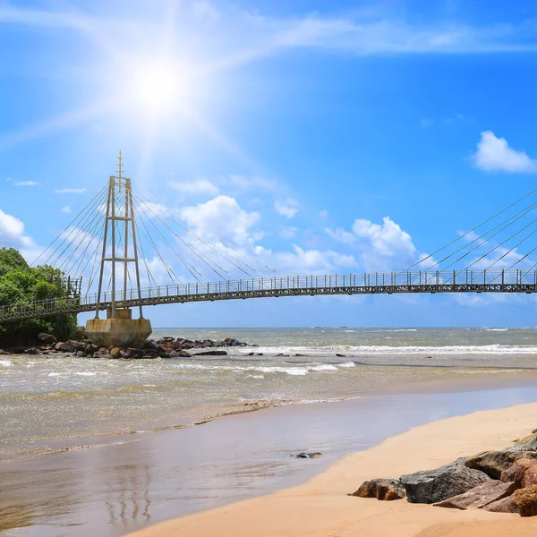 Pedestrian bridge on an island in the ocean . Matara. Sri Lanka.