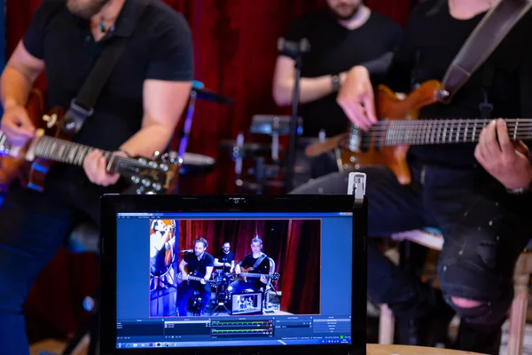 Konser sırasında elektro gitar, bas gitar ve davul çalan müzisyen grubu bardaki sosyal medya platformlarında çevrimiçi yayın yapıyor.