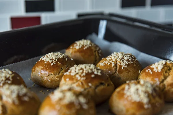 Pastries in a black baking tray in the kitchen