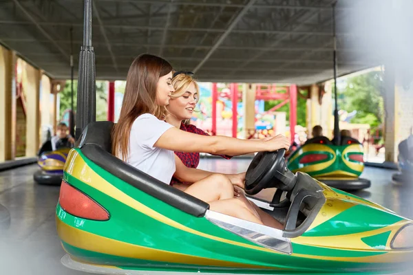 Two Girls Holding Steer While Driving Car Amusement Park Summer — Stock Photo, Image