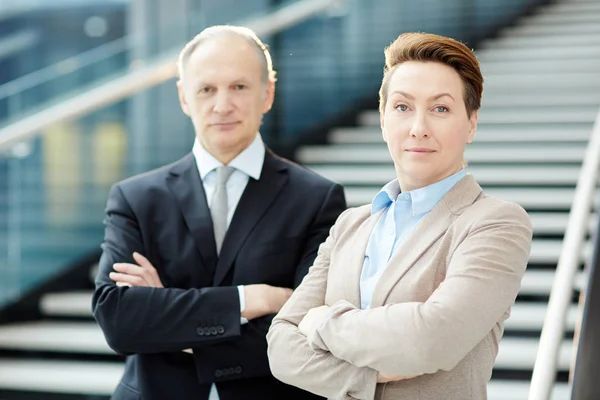 Elegant Mature Businessman Businesswoman Looking Camera Crossed Arms Staircase Airport — Stock Photo, Image