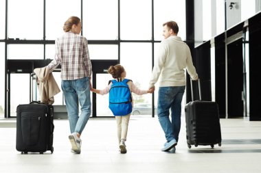 Anne ve küçük kız görünümünü geldikten sonra Havaalanı lounge yürüyüş bagaj ile geri