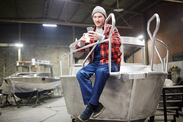 Young Engineer Workwear Texting Smartphone Coffee Break Shipbuilding Factory — Stock Photo, Image