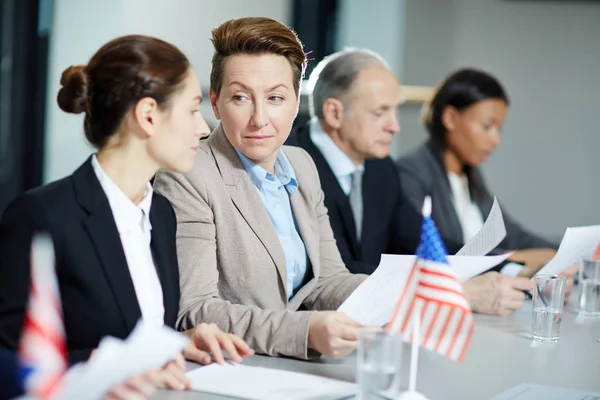 Mature Delegate Showing Papers Political Partner Sitting Next Her Background — Stock Photo, Image