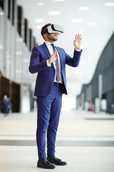 Young Businessman Formalwear Headset Standing Modern Building Touching Virtual Display — Stock Photo, Image