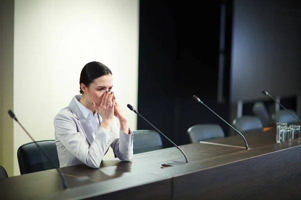 Upset Businesswoman Sitting Tribune Mike Front Keeping Her Hands Face — Stock Photo, Image