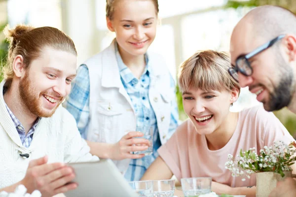 Four Happy Friends Watching Curious Movie Video Touchpad While Gathering — Stock Photo, Image