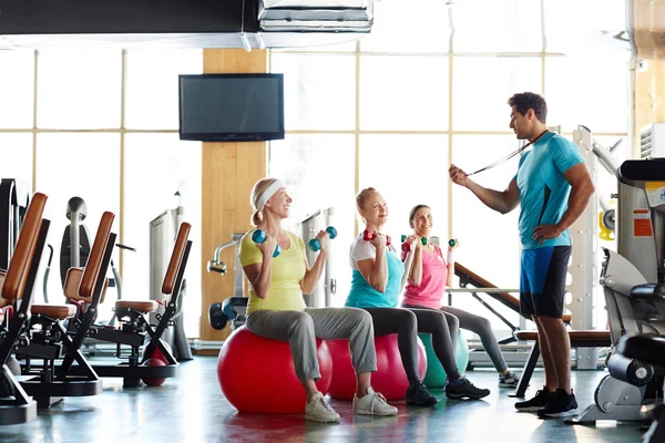 Group Active Retired Females Sitting Fitballs Exercising Dumbbells Looking Coach — Stock Photo, Image