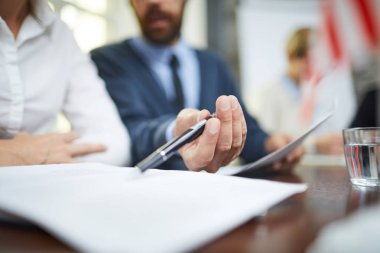 Delegelerden biri siyasi zirvede meslektaşına verileri açıklarken kağıda işaret ediyor.