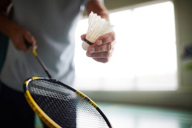 Badminton oyuncu tutarak raket ve raketle atmak ve oyun başında vurmak için gidiyor