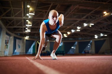 Tarafından start çizgisinde yarış pisti üzerinde duran ve işareti gitmek bekliyoruz özürlü bacaklı genç Etkin atlet