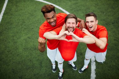 Üç genç Futbol Şampiyonlar Alan üzerinde üniforma daimi zafer ifade ederken