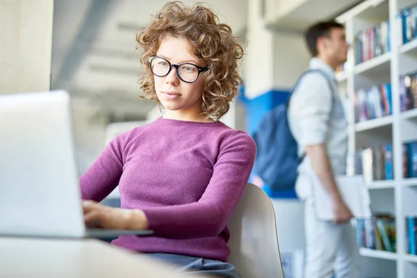 Young Curly Woman Eyeglasses Sitting Working Laptop College Library — 스톡 사진