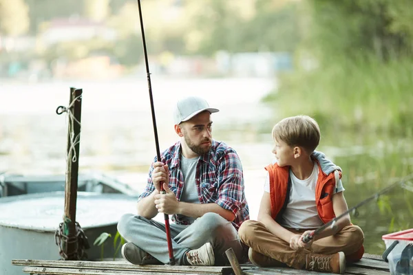 Young Man Rod His Son Sitting Wooden Pontoon Talking While — 스톡 사진