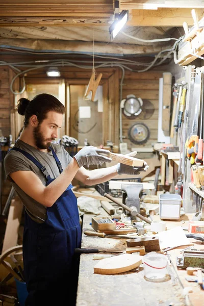 Young Man Shirt Overalls Looking Wooden Workpiece His Workplace — 스톡 사진