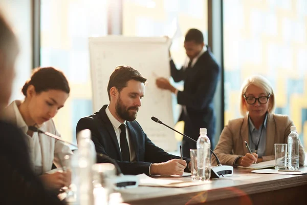 Group Confident Participants Sitting Table Making Notes Preparing Reports Conference — Stock Photo, Image