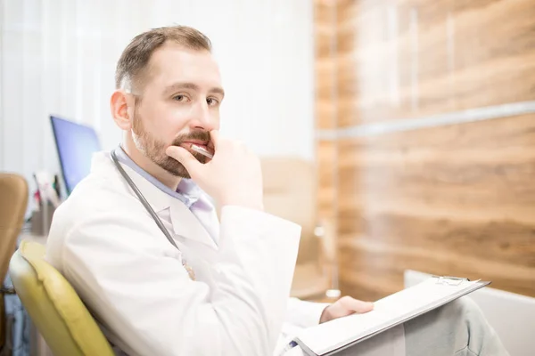 Young Pensive Doctor Hand His Face Looking Camera Making Medical — Stok fotoğraf