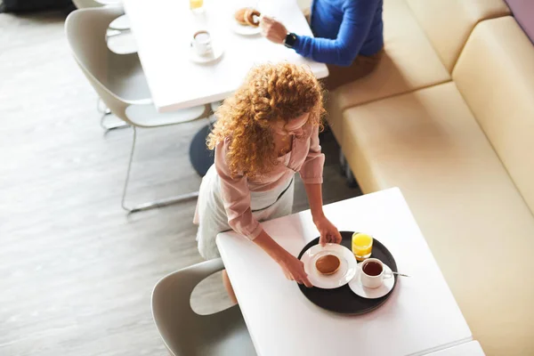 Directly View Curly Haired Young Waitress Standing Table Putting Plate — Stock Photo, Image