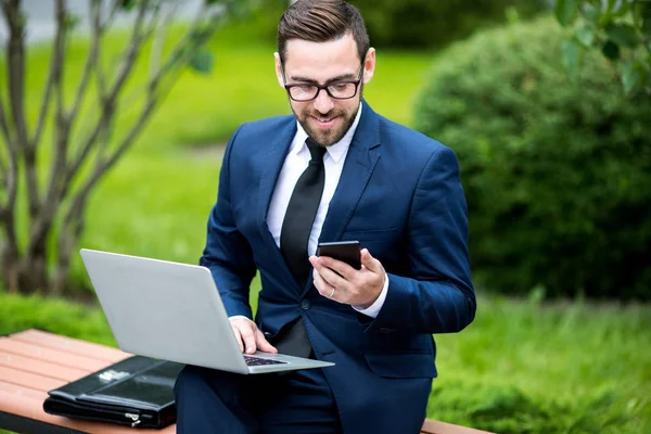 Young Stylish Laughing Male Business Dress Eyeglasses Laptop Looking Smartphone — Stock Photo, Image
