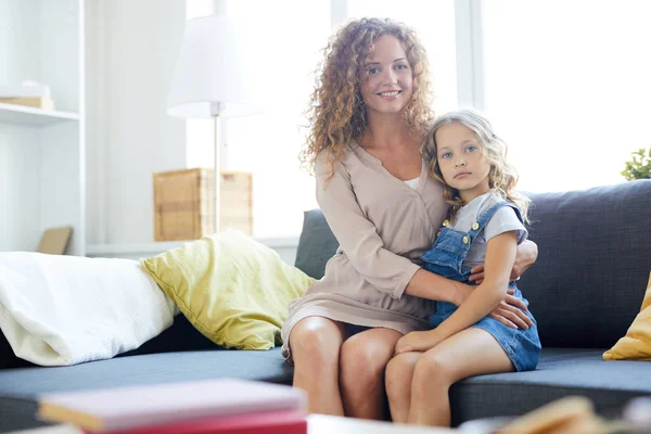 Jonge Vrouw Met Krullend Haar Omarmen Haar Dochtertje Terwijl Beide — Stockfoto