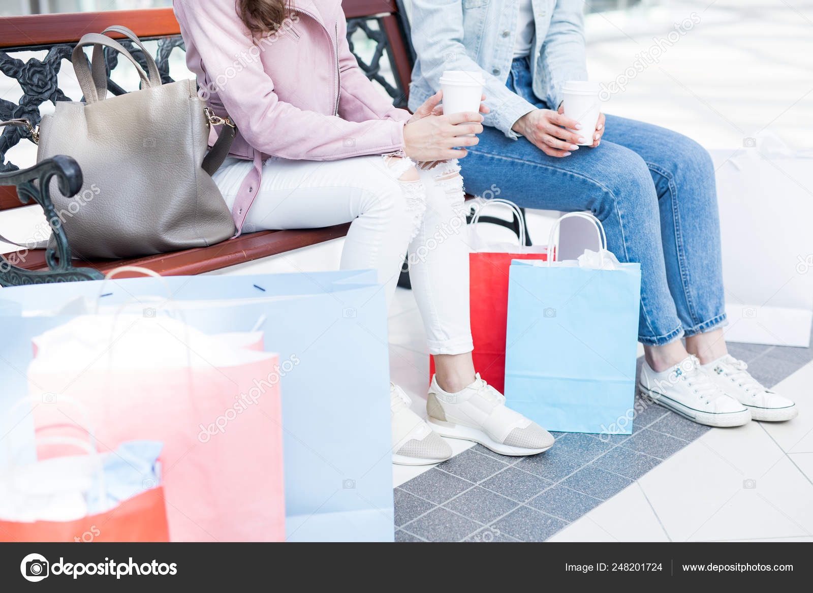 Two Girls Jeans Jackets Sitting Bench Having Drinks Shopping