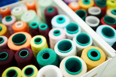 Konteyner kutusunda birçok parlak iş parçacığı makaraları arka plan görüntüsü