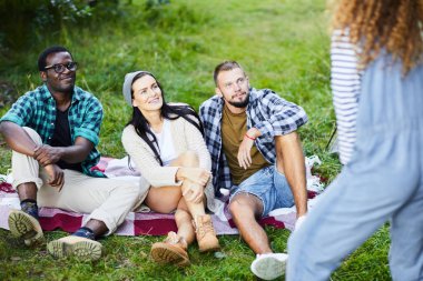 Üç genç arkadaş boş zamanlarında oyunun konusunu tahmin etmeye çalışırken kız bakıyor