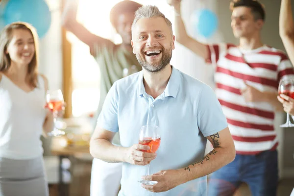 Cheerful Laughing Man Red Drink Looking You While Enjoying Home — Stock Photo, Image