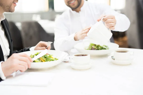 One Business Partners Pouring Hot Tea Teapot Cup Business Lunch — Stock Photo, Image