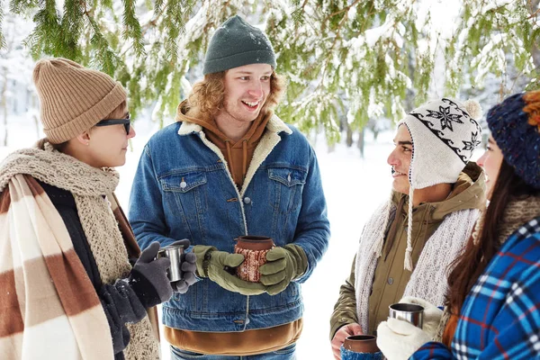 一群年轻人在冬天的森林里喝热可可 边聊天边享受度假时光 — 图库照片