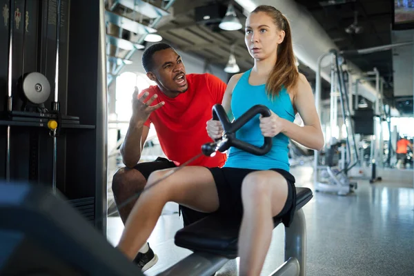 Sports Coach Encouraging Young Woman Rowing Machine Work Harder Training — Stock Photo, Image