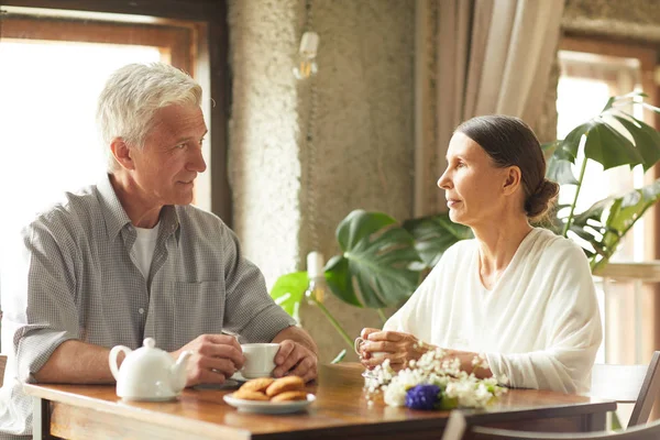 Restful Senior Couple Sitting Table Cafe Having Tea Cookies Talking — Stock Photo, Image