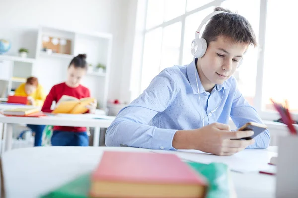 Restful Schoolboy Headphones Choosing Song Playlist Smartphone Break Lessons — Stock Photo, Image