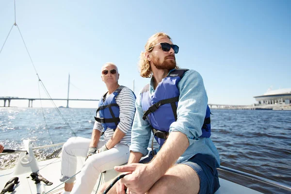 Pensive Dreamy Male Tourists Sunglasses Wearing Life Jackets Sitting Sailboat — Stock Photo, Image