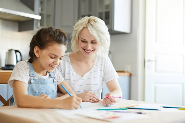 Kleines Mädchen Zeichnet Etwas Auf Papier Während Ihre Mutter Der — Stockfoto